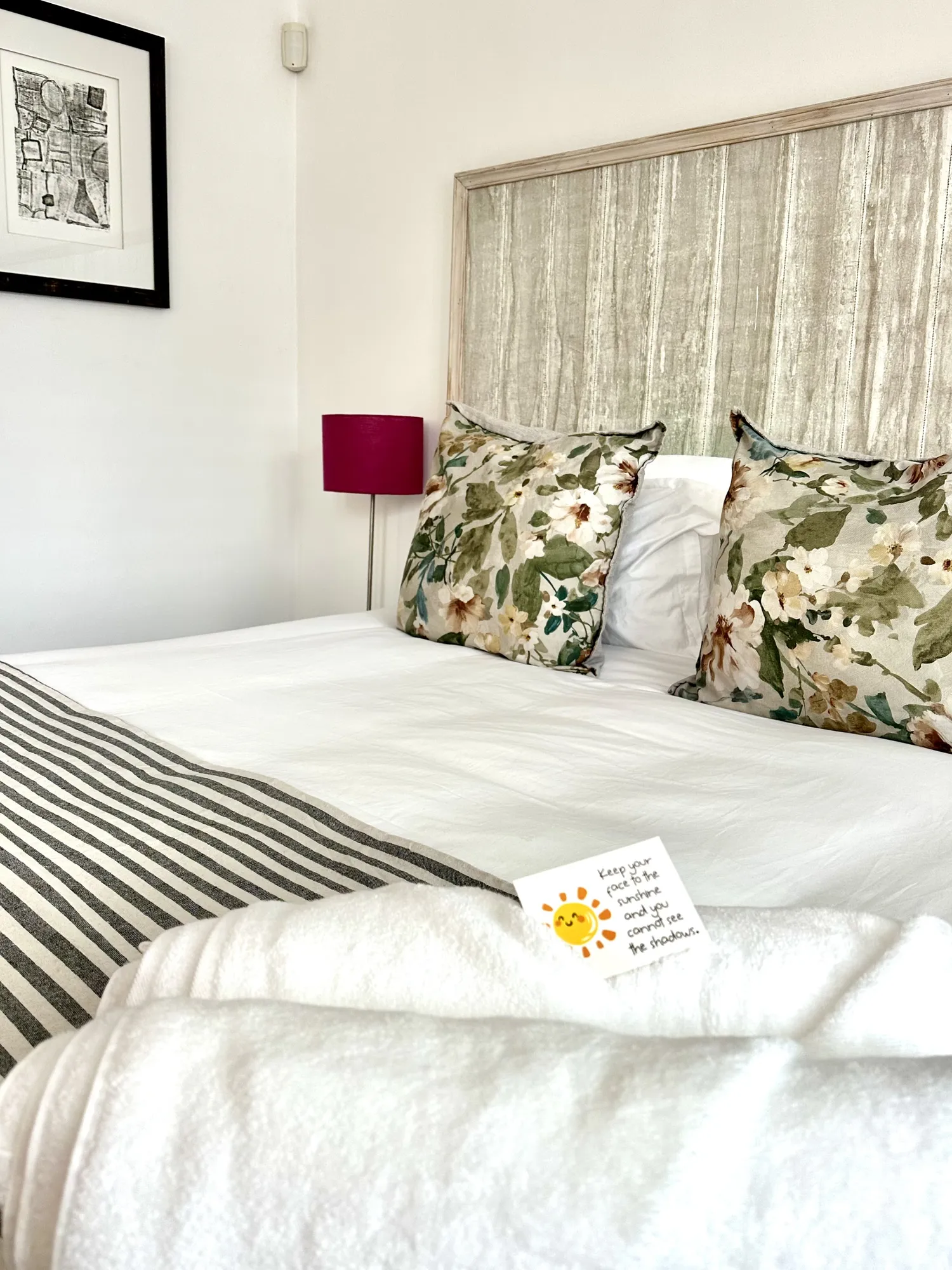 Floral cushions on a made bed at Casa Dias