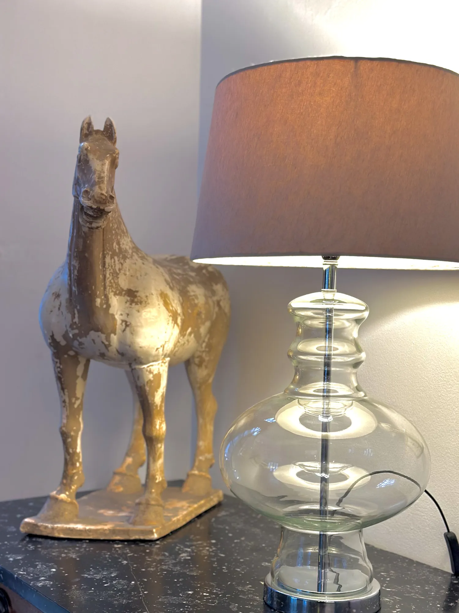 A glass lamp and horse sculpture in the Casa Dias living room